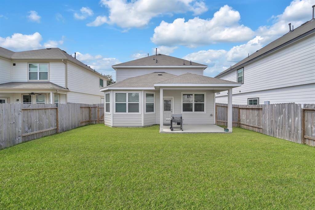 Large, private backyard with covered patio.
