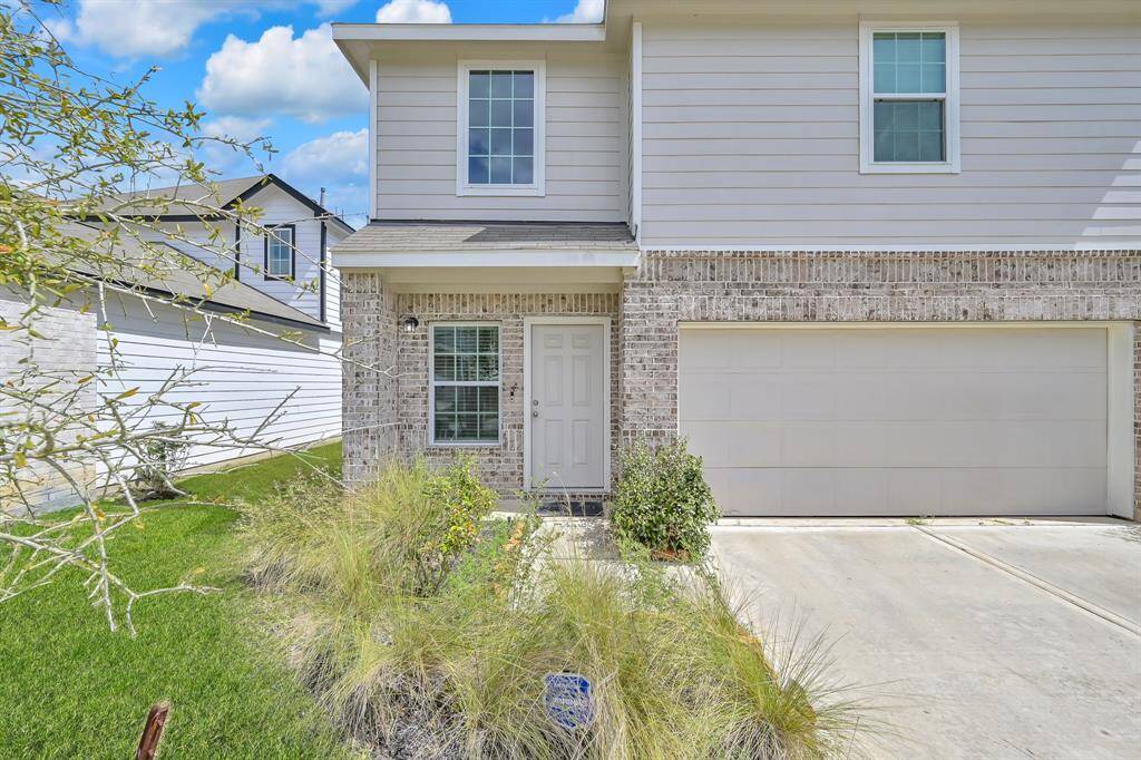 Welcoming front exterior with attached two-car garage.