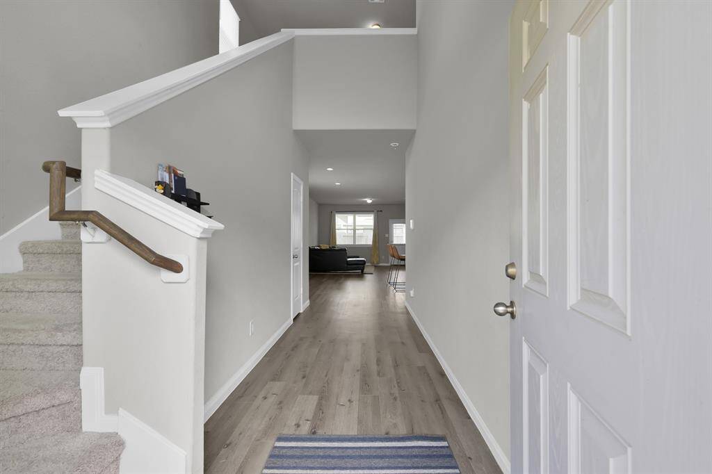 Bright and open entryway with stylish flooring.