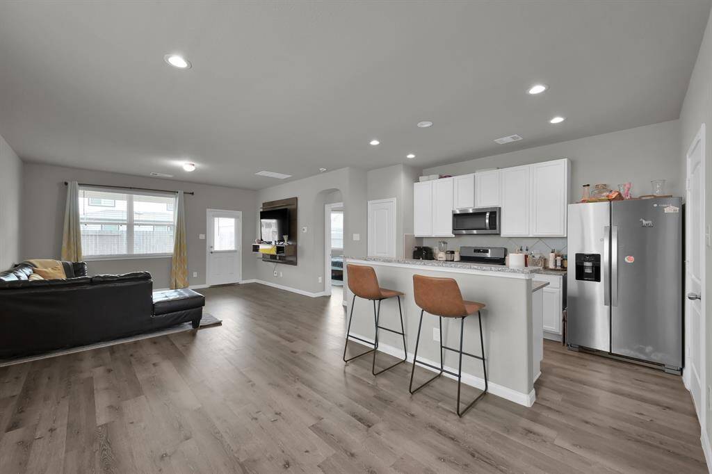 Spacious open-concept living, dining, and kitchen.