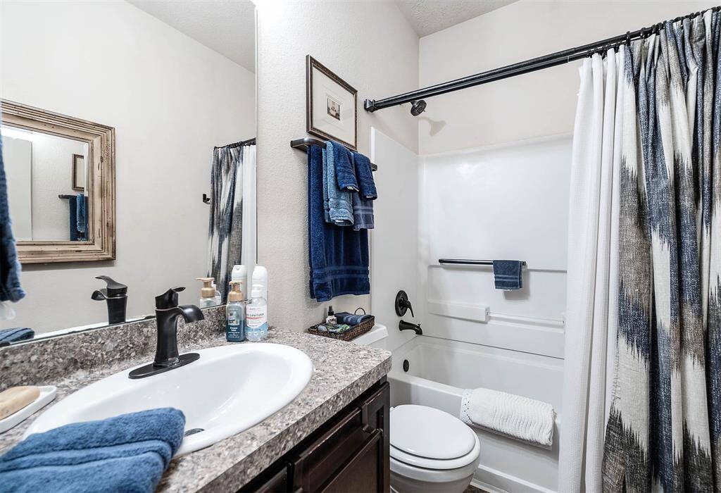 Stylish second bathroom featuring a convenient shower-bath combo.