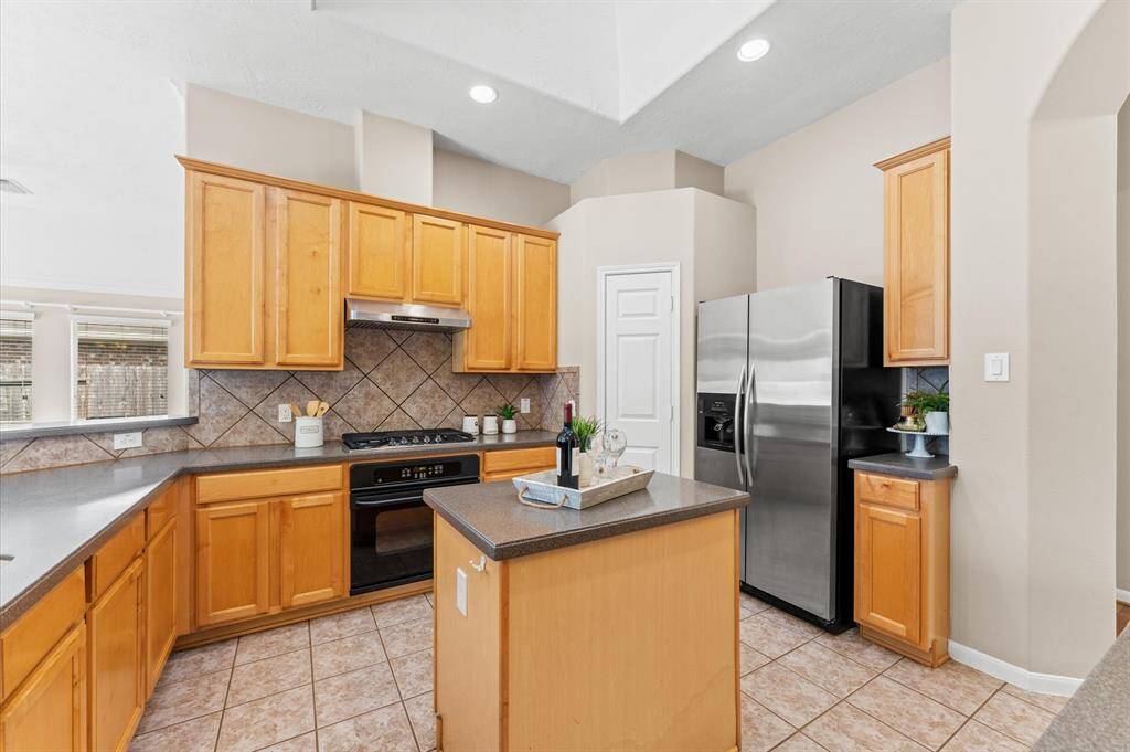 Stainless steel appliances add a modern touch, making cooking a joy. A tile backsplash adds character and warmth, tying the space together beautifully.