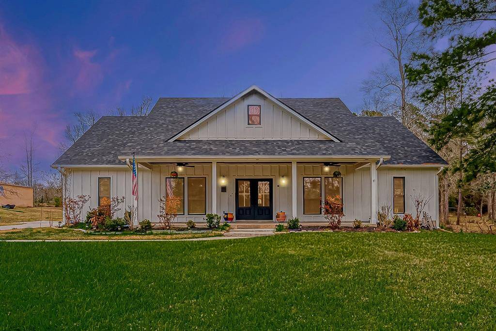 Picture-perfect farmhouse design with a welcoming long porch.