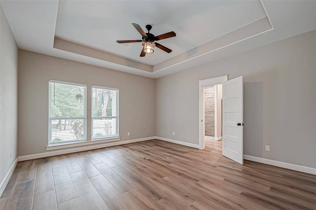 The primary bedroom features vaulted ceilings and no carpet.