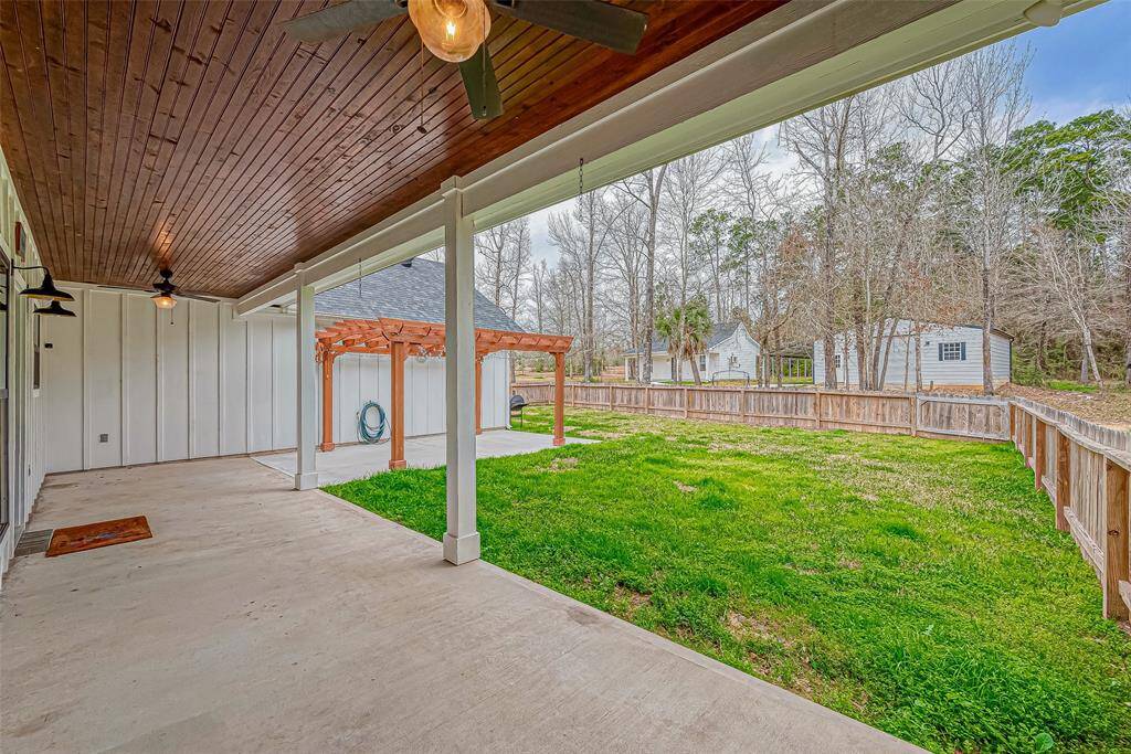 The fenced, covered back porch is perfect for your furry friends.