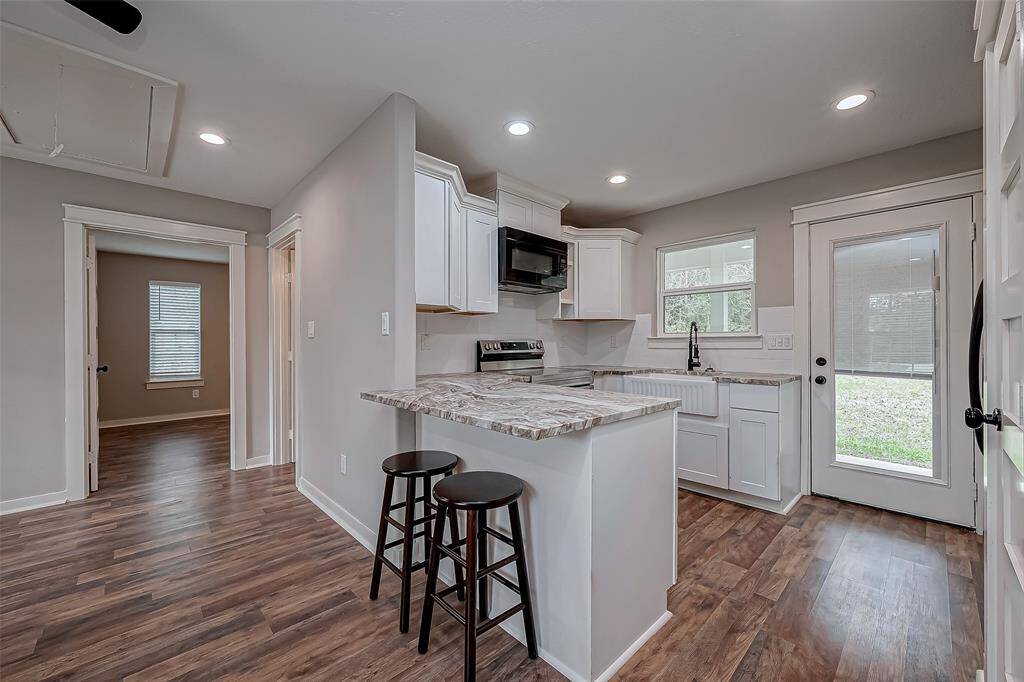 The kitchen is totally equipped with a full-size setup, and a breakfast bar seating.