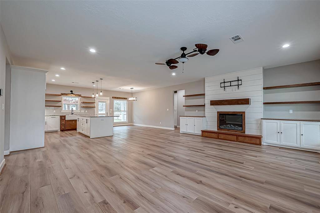 The open-concept layout showcases custom wood cabinetry.