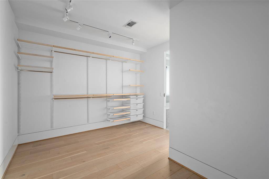 The primary closet offers plenty of space for all your storage needs.
