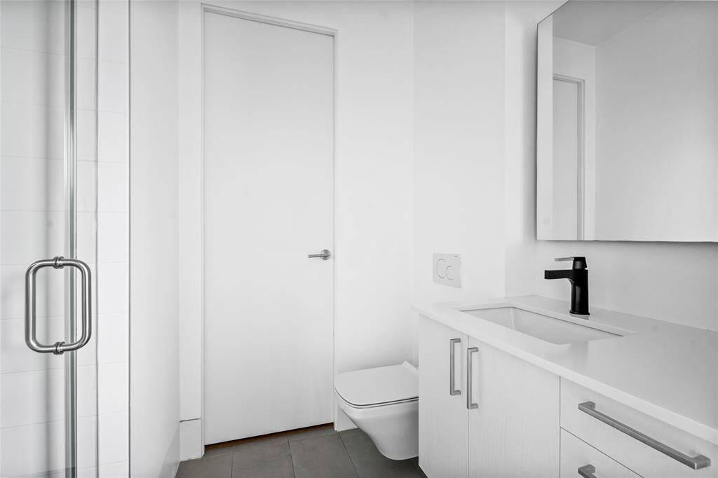 The bright en-suite bathroom leads to the secondary closet, offering additional storage space.