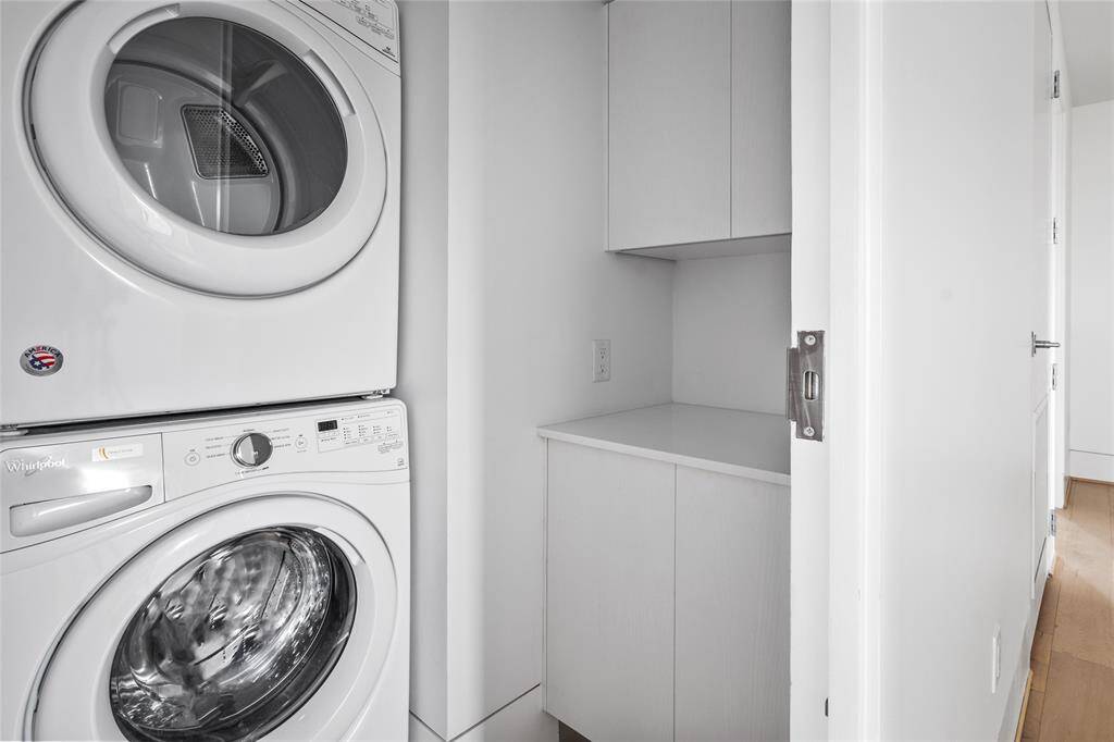 Utility room in unit with full size washer and dryer.