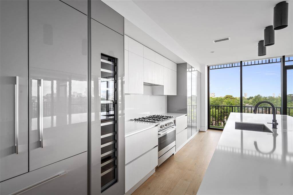 Included are high-end kitchen appliances and a spacious wine refrigerator.