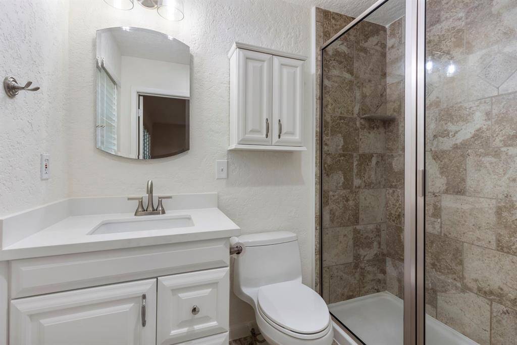 Primary bath has oversized shower, new countertop, sink & faucet.