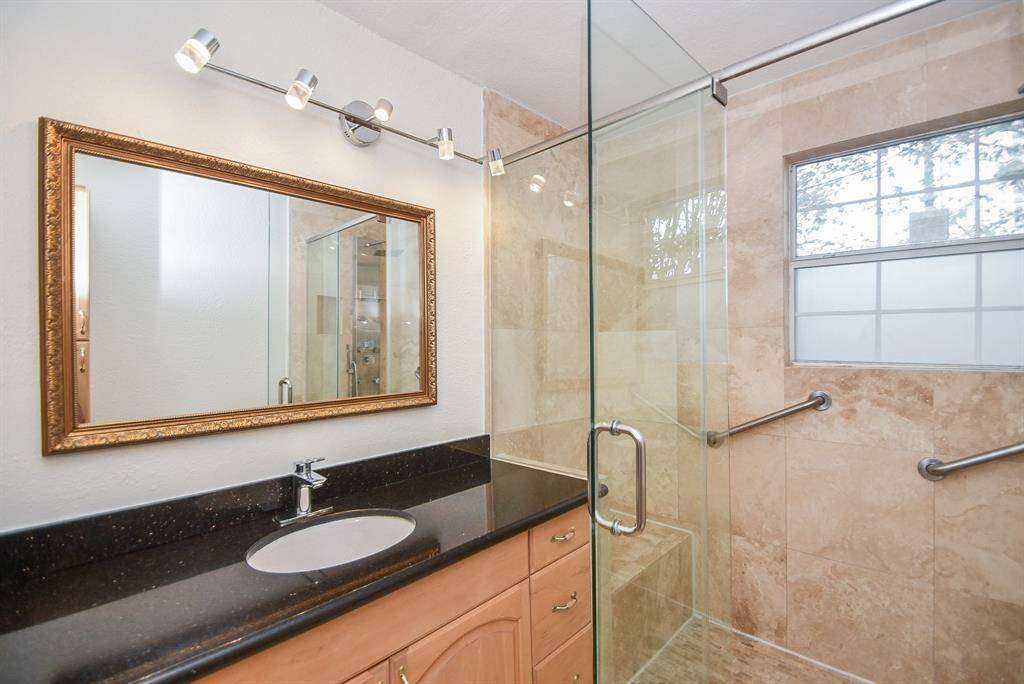 The primary bath has a seated bench in the shower.