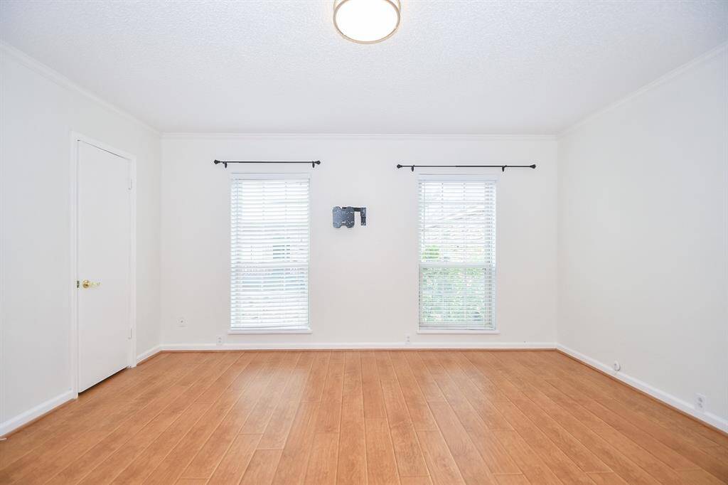 A view of the primary bedroom with TV mount