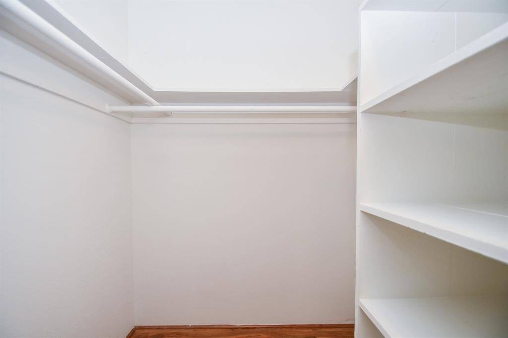 Walk-in closet with shelves in secondary bedroom