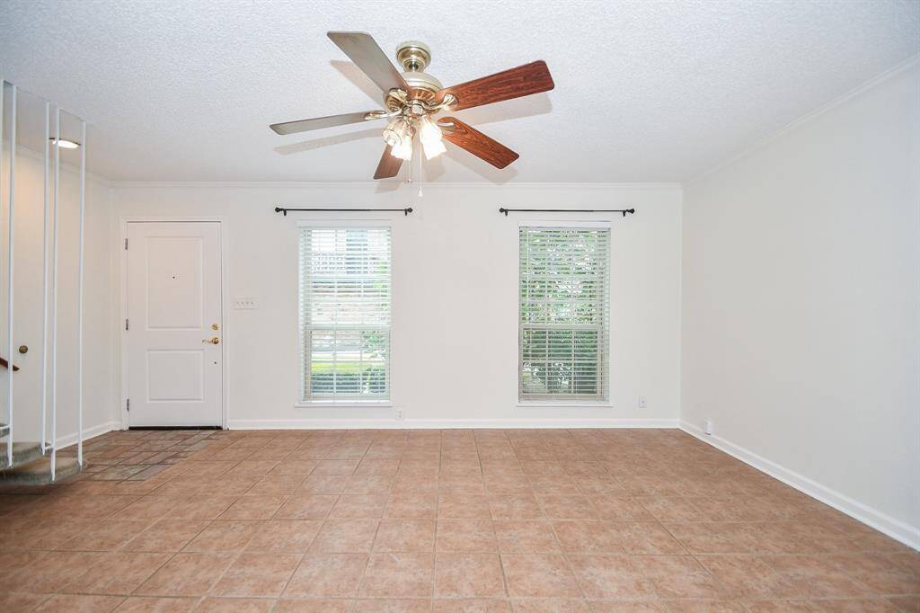 View of the spacious living room and front door. Plenty of natural light.