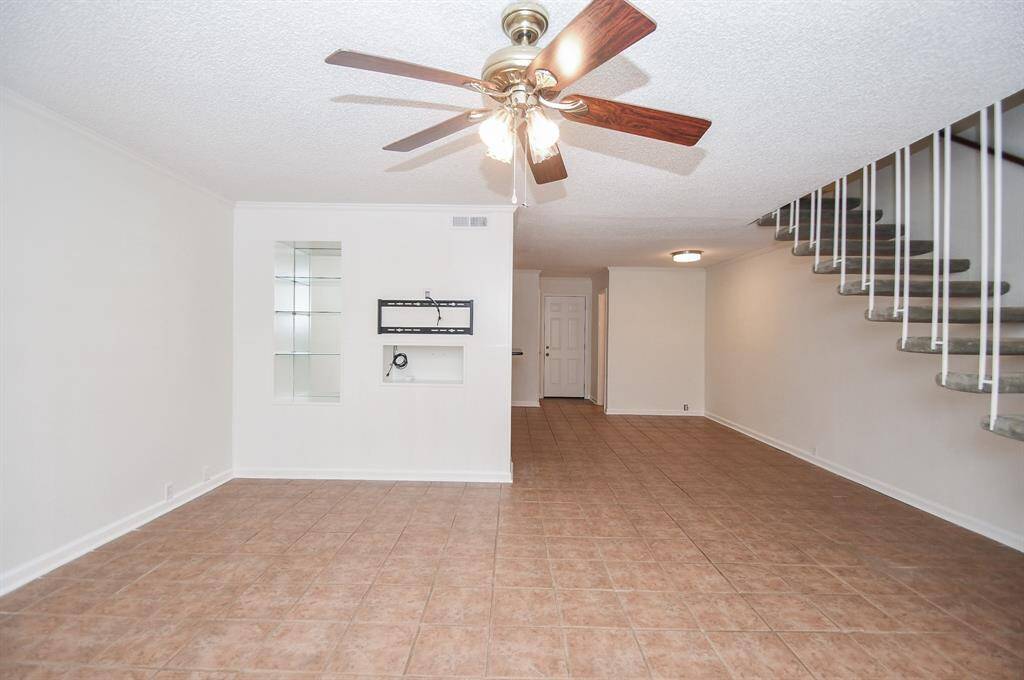 View the TV mount and shelves in the living room and dining room.