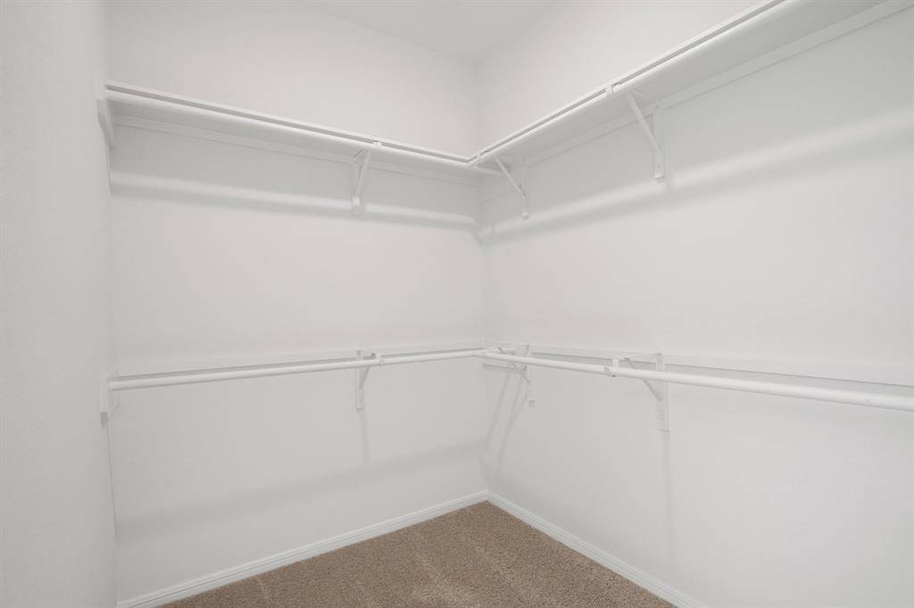 A view of your large primary walk-in Closet