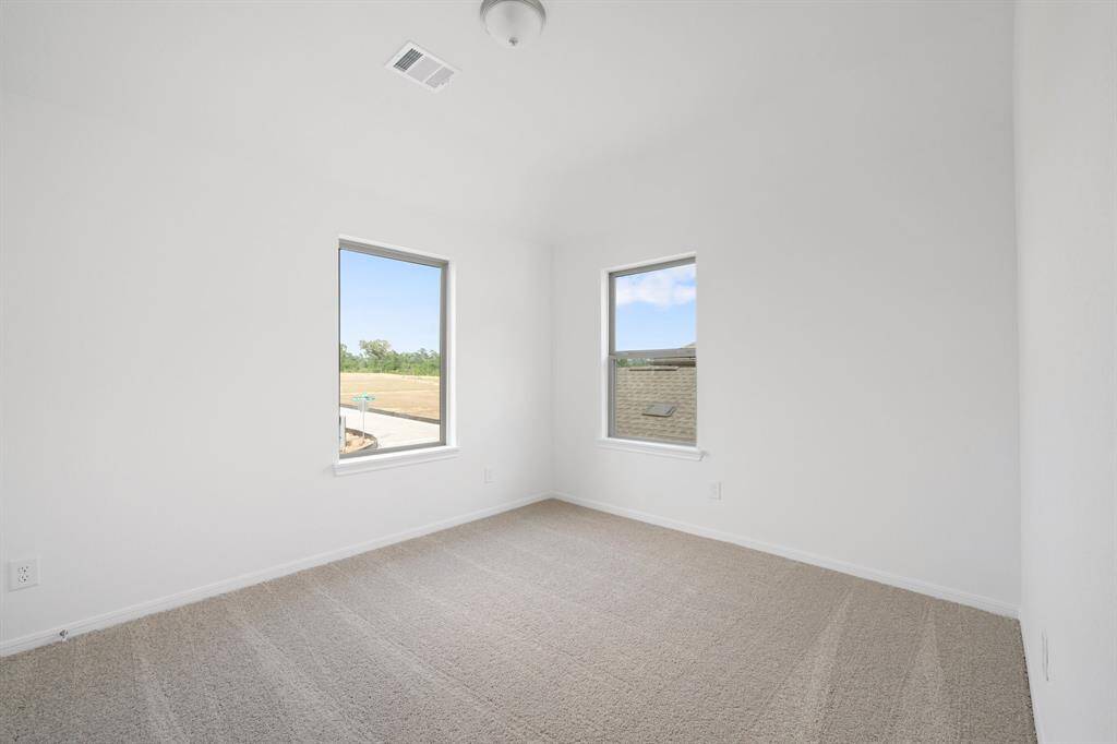 Your secondary bedroom features plush carpet, fresh paint, closet, and a large window that lets in plenty of natural lighting.