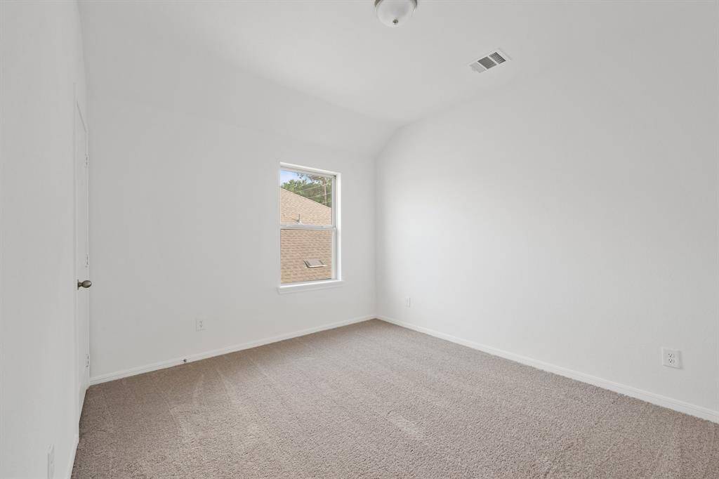 Your secondary bedroom features plush carpet, fresh paint, closet, and a large window that lets in plenty of natural lighting.
