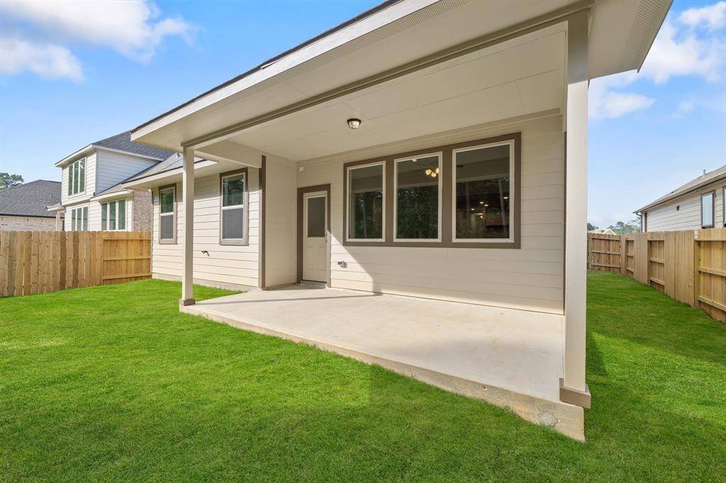 The covered patio is generously sized, providing ample space for various outdoor activities.