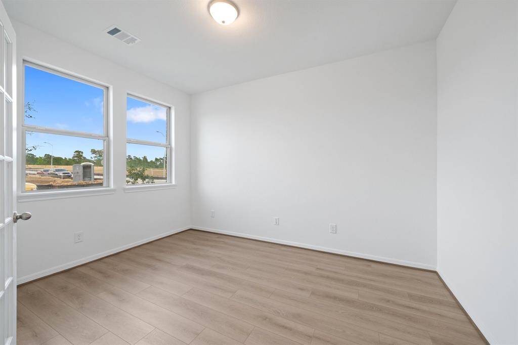 The home office features French doors, beautiful floors, large windows that give a fresh feel, this space promotes focus and creativity.