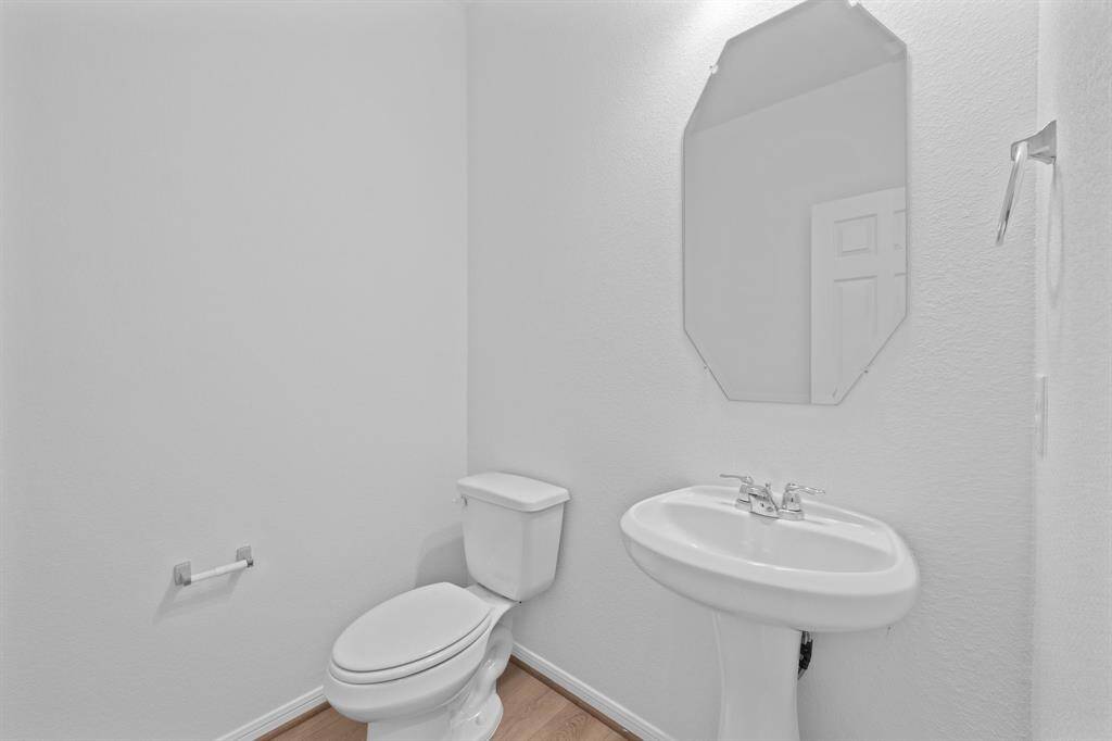 This charming home features a beautifully appointed half bath adjacent to the family room, perfect for welcoming guests and adding convenience to your daily life.