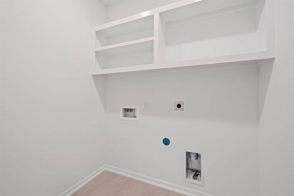 The laundry room layout is carefully planned for optimal workflow with designated areas for washing, drying, and storing.
