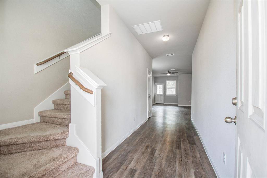 Entry into home, Luxury vinyl plank flooring through out common areas, carpet in living areas.