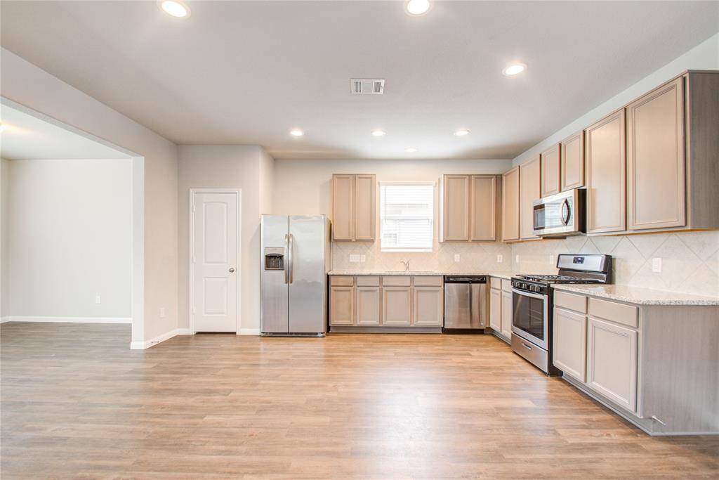 Stainless steel appliances flex room off kitchen