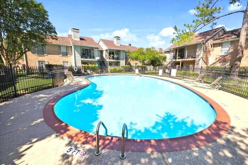 Inviting community pool surrounded by comfortable lounge chairs, perfect for relaxing, soaking up the sun, and enjoying resort-style living just steps from your door.