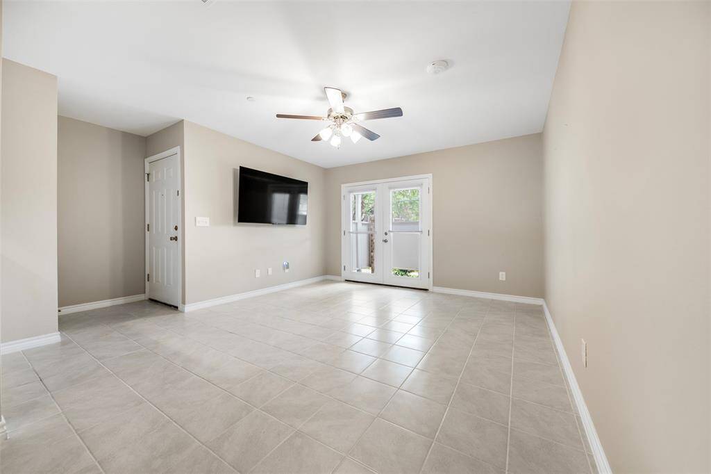 Spacious living room with an open floor plan that flows seamlessly into the dining area, offering a welcoming entryway, neutral tones, and plenty of natural light—ideal for both relaxing and entertaining.
