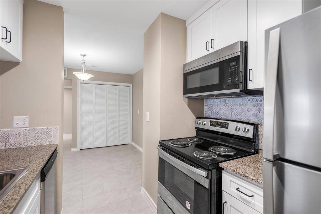 This angle highlights the kitchen’s seamless connection to the dining room, creating an open and inviting space perfect for everyday living and entertaining.