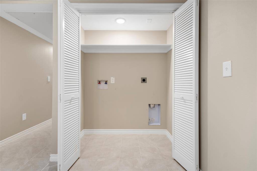 Convenient laundry closet located just off the dining room, designed to fit a washer and dryer—offering easy access and tucked-away functionality without compromising style.