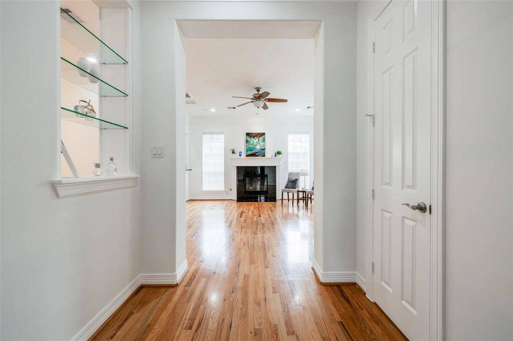 Enjoy first floor living - this beautiful home has a wide hallway, hardwood floors, glass display shelves & door to half bathroom
