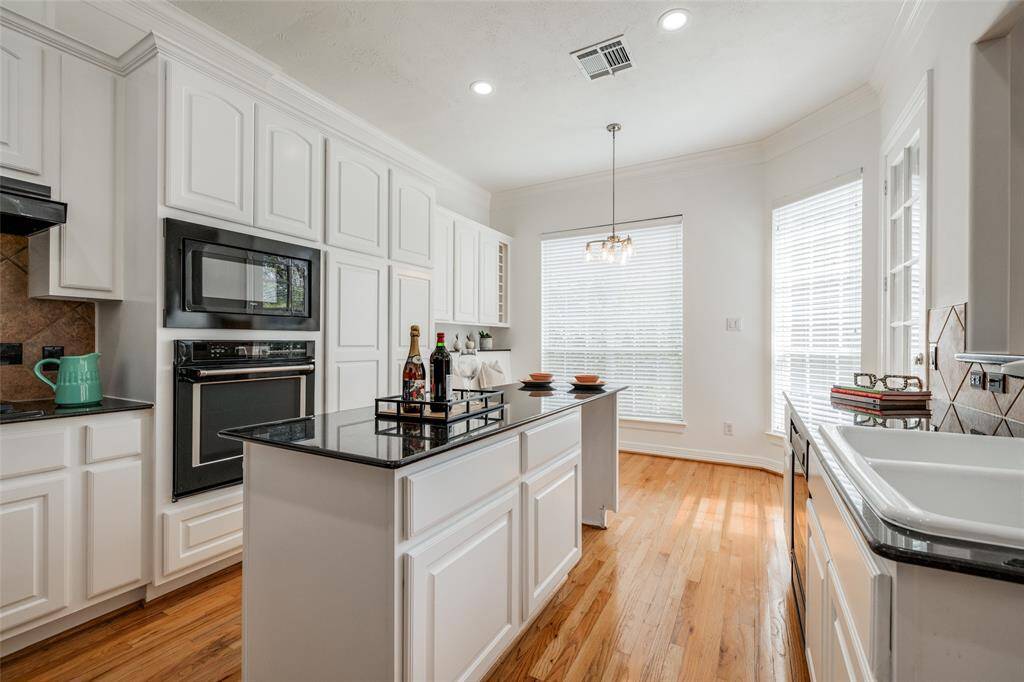 Large open plan kitchen with lots of cabinets, island with no sink or cooker - great for entertaining