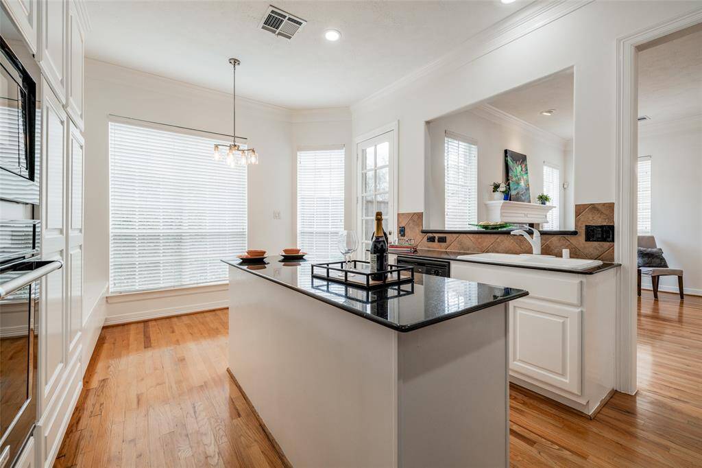 Large kitchen with newly painted cabinets, granite counters, island with no cooker - great for entertaining