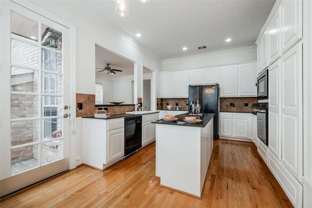 Spacious Kitchen with recently painted white cabinets, single oven, microwave, white sink