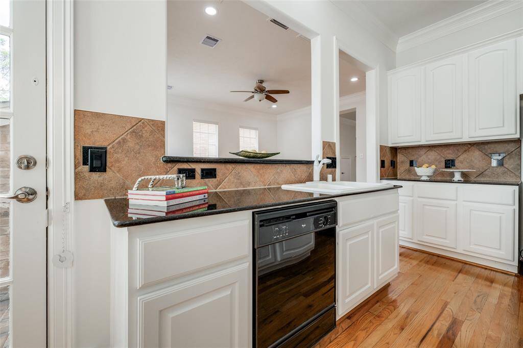 Spacious Kitchen with recently painted white cabinets, single oven, microwave, white sink