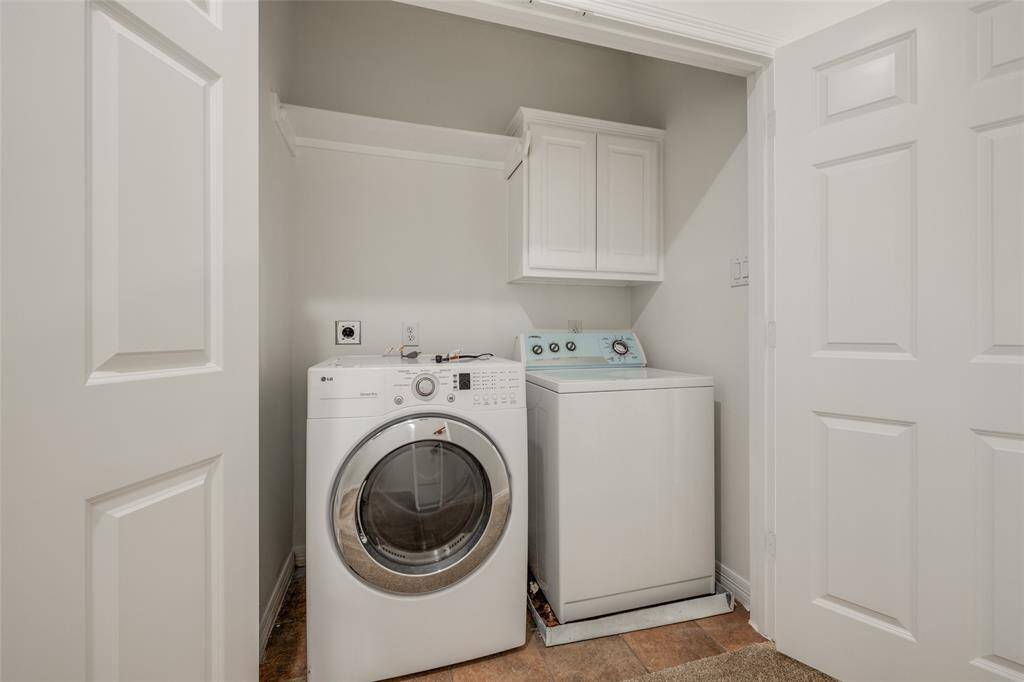 Laundry room on second floor with washer & dryer included in sales price, cabinet for storage