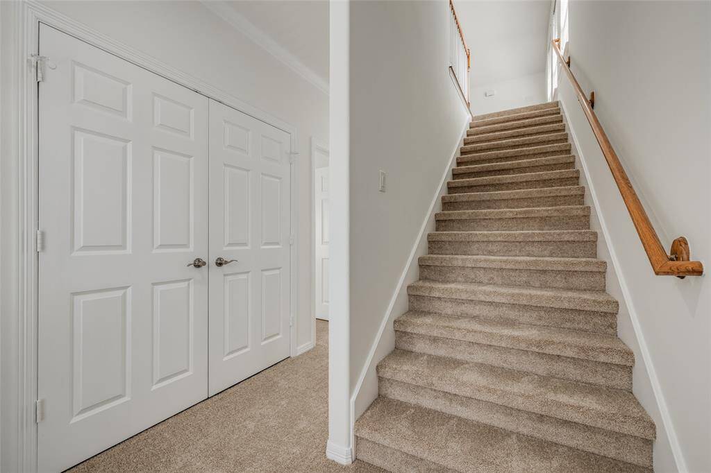 Stairs to third level with wooden handrail