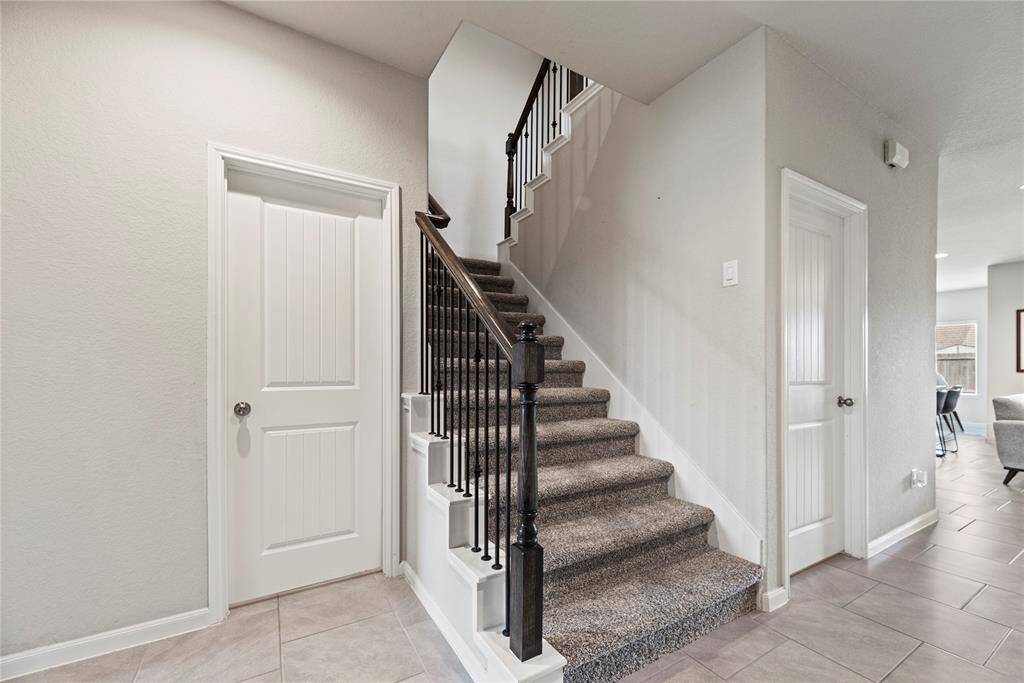 The second staircase, seamlessly connecting to the upstairs, offers unparalleled convenience and accessibility.