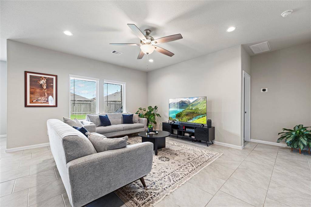 This chic living room space has a great feel with tons of natural light coming from the wall of windows.