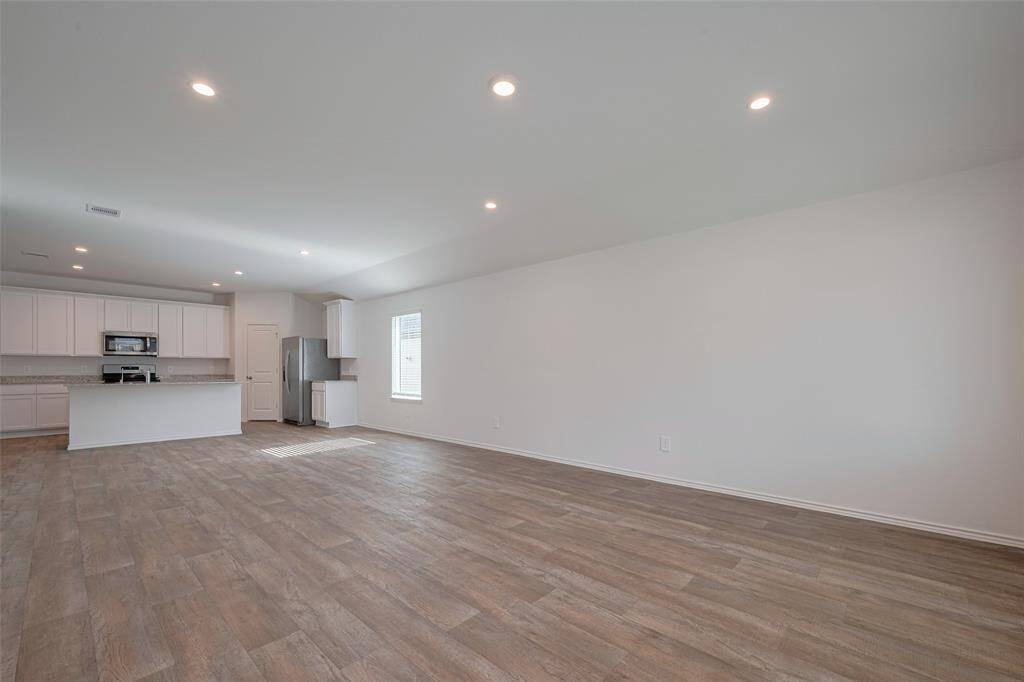 This expansive open-concept layout connects the kitchen, dining area, and living room—allowing effortless flow for both daily living and gathering with guests.