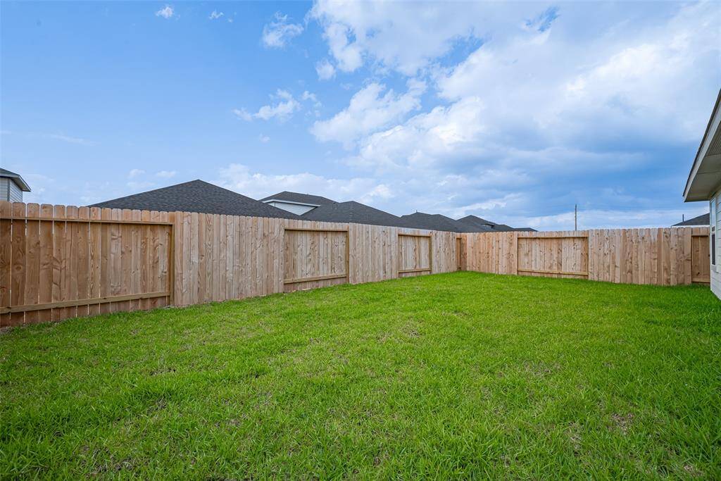 Step into a generous backyard escape, fully fenced and blanketed in green grass—perfect for play, gardening, or simply unwinding in open air.