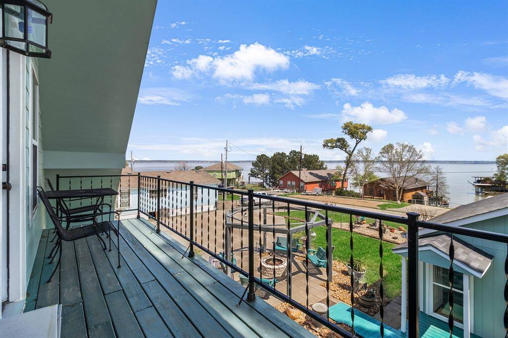 The balcony connected to the primary suite offers stunning views of the sunrise and sunset, the lake, and the beautiful scenery.