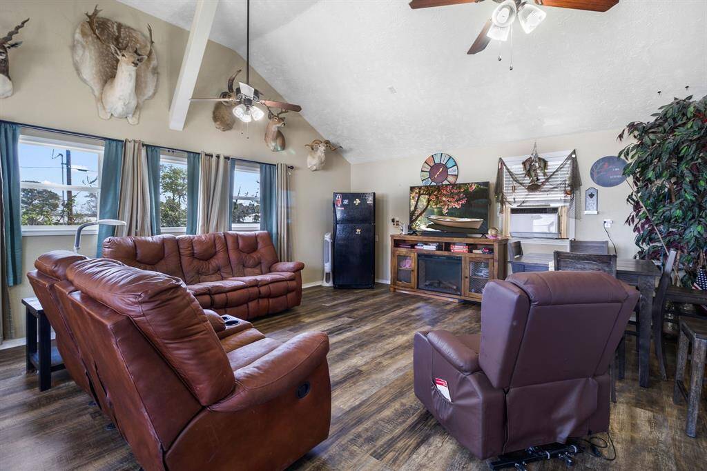 This cozy guest quarters/flex space features vaulted ceilings, wood flooring, and large windows with ample natural light.
