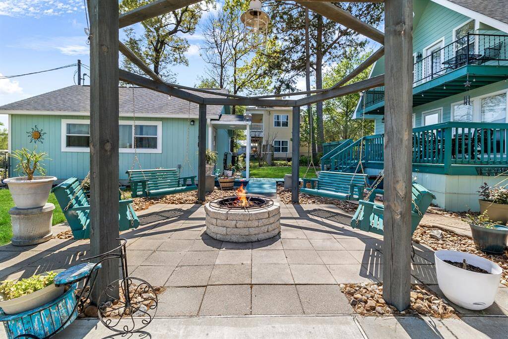 Cozy fire pit area is the perfect spot for unwinding and taking in the amazing lake views.