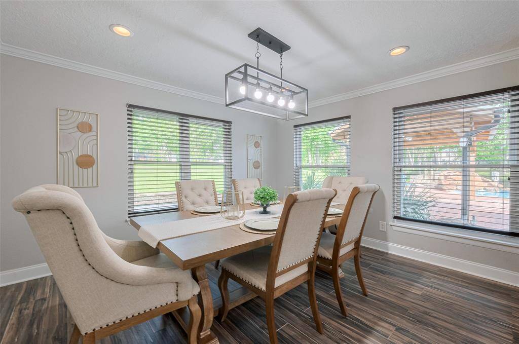 Enjoy your meals in this well-lit dining area, featuring large windows that provide a view of the backyard oasis. It's the perfect setting for both intimate dinners and larger gatherings. With ample space and updated design, this room will make every dining experience feel special.