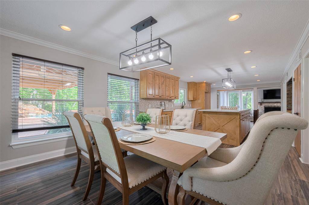 Enjoy your meals in this well-lit dining area, featuring large windows that provide a view of the backyard oasis. It's the perfect setting for both intimate dinners and larger gatherings. With ample space and updated design, this room will make every dining experience feel special.